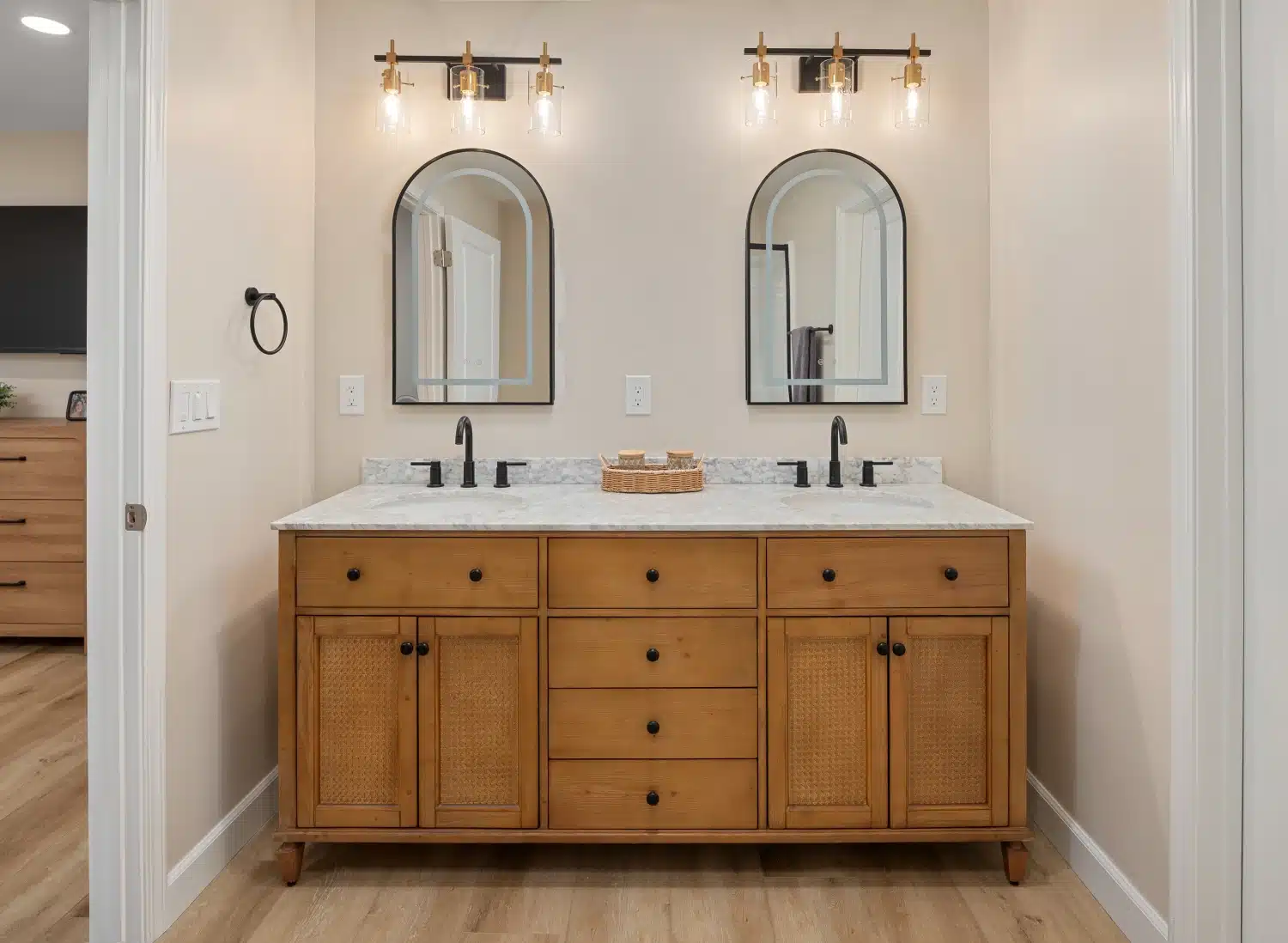 Double oak vanity with twin arched mirrors and black sconce lighting