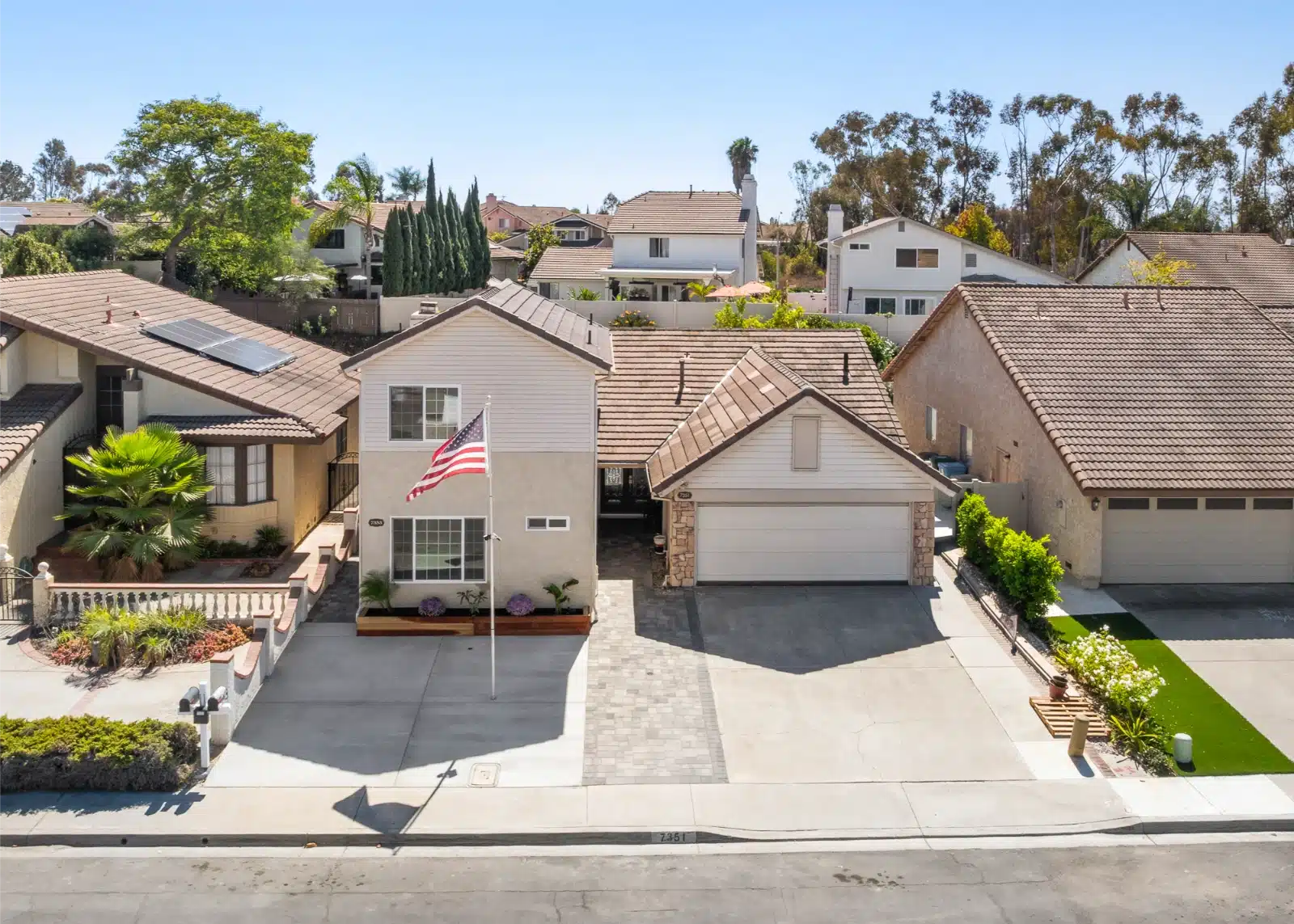 Aerial view of the street with the two-story addition at the front of the lot