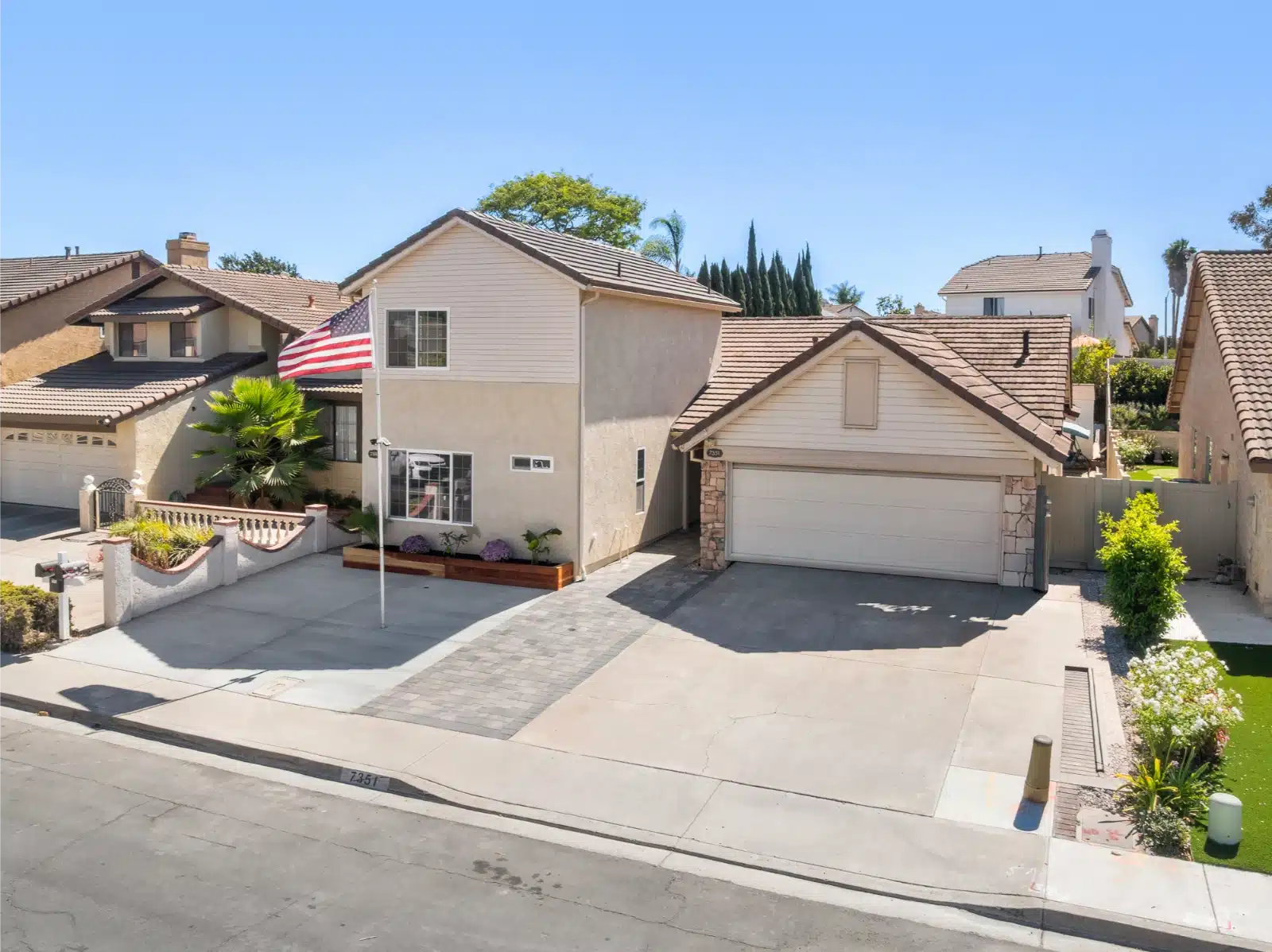 Two-story addition built at the front of the lot, beside the existing house and garage