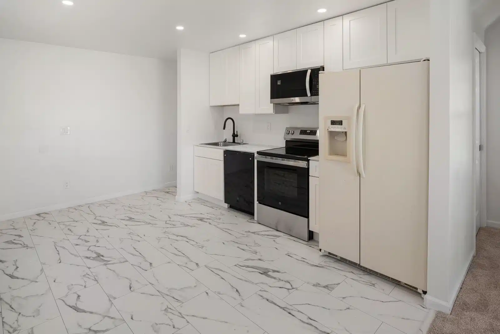 The kitchen with a full-size refrigerator, range and microwave