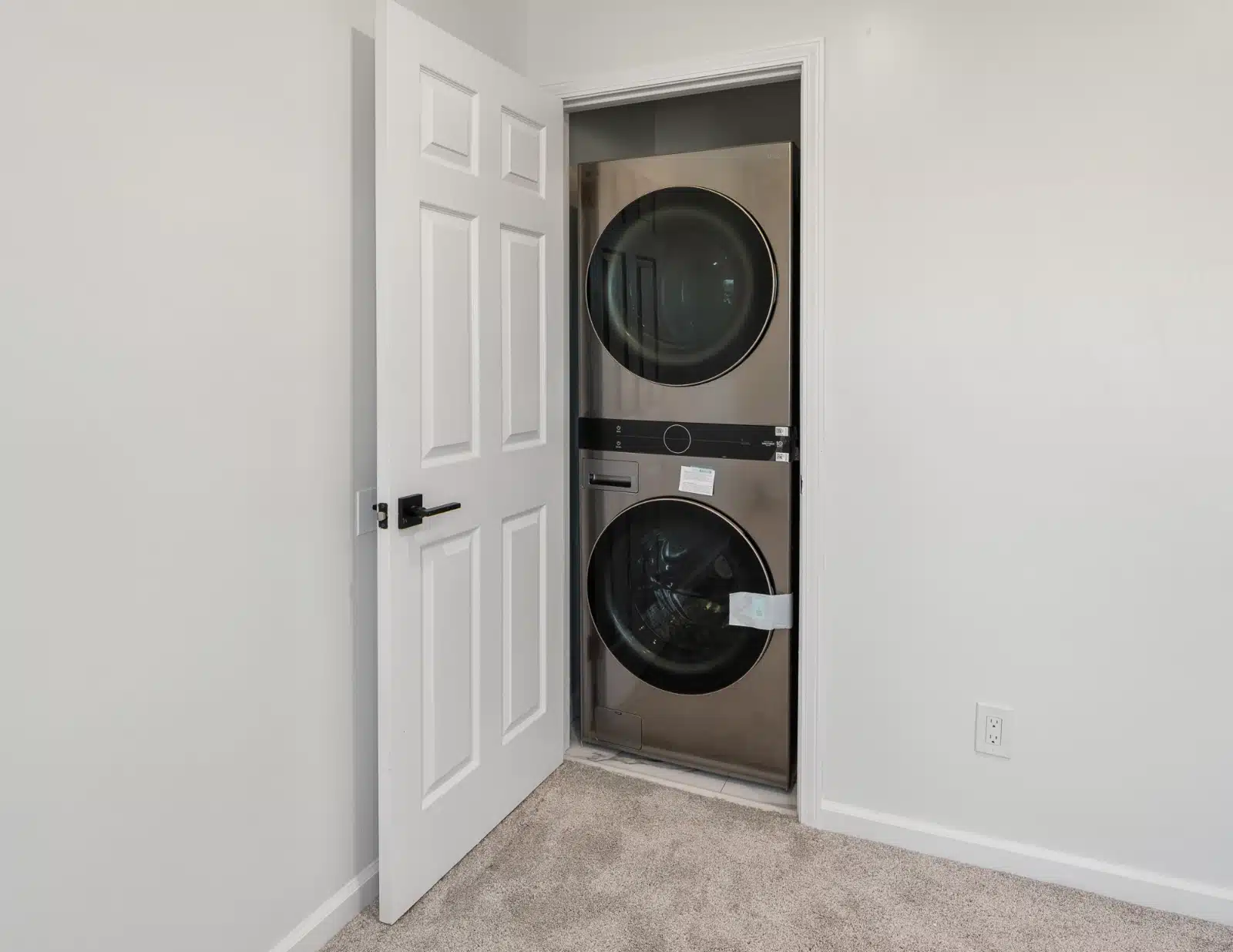 Stacked washer and dryer in a closet inside the addition