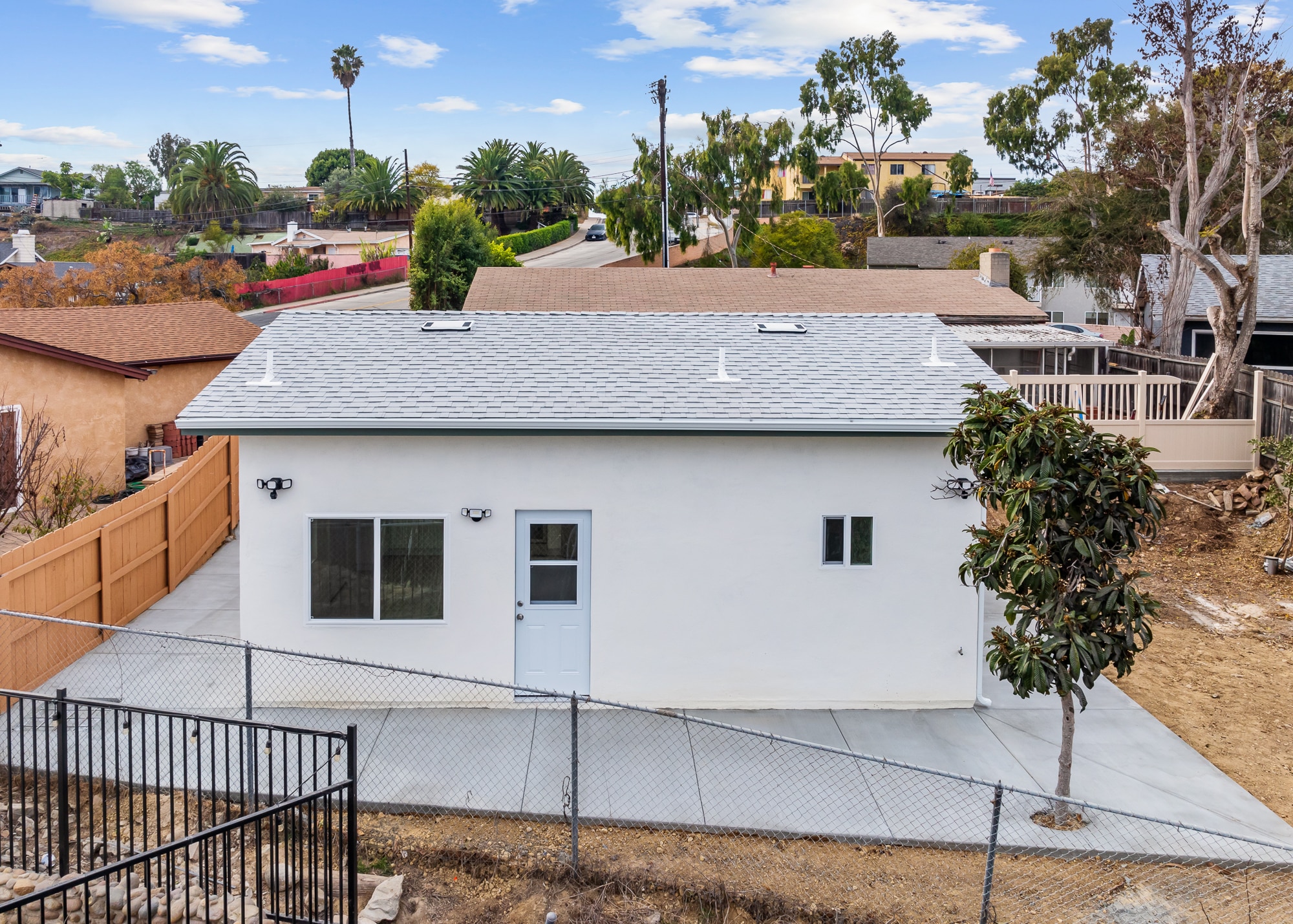 The completed detached ADU seen from above the rear yard, with its entry door and windows