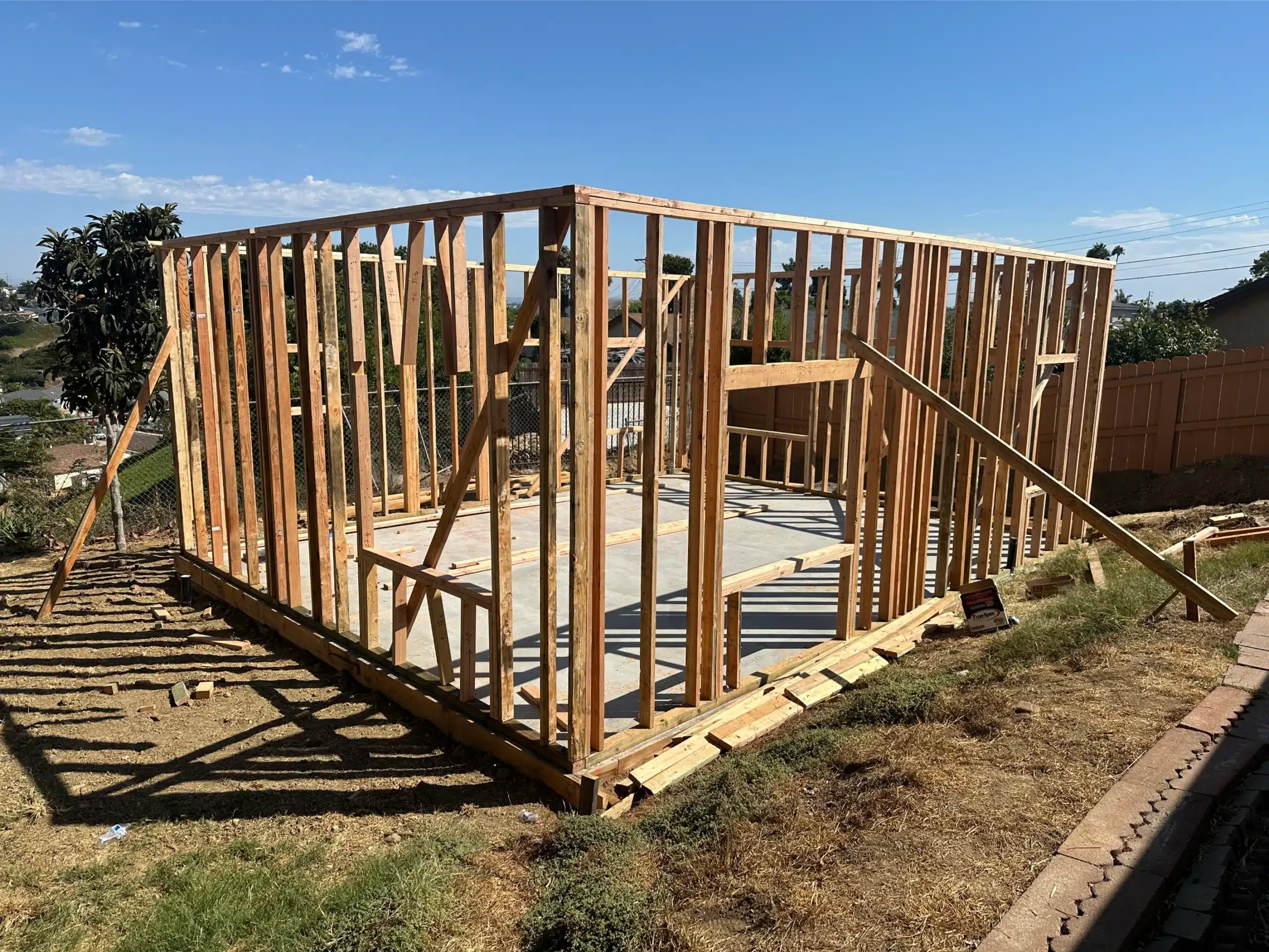 ADU exterior walls framed on the slab, with door and window openings formed