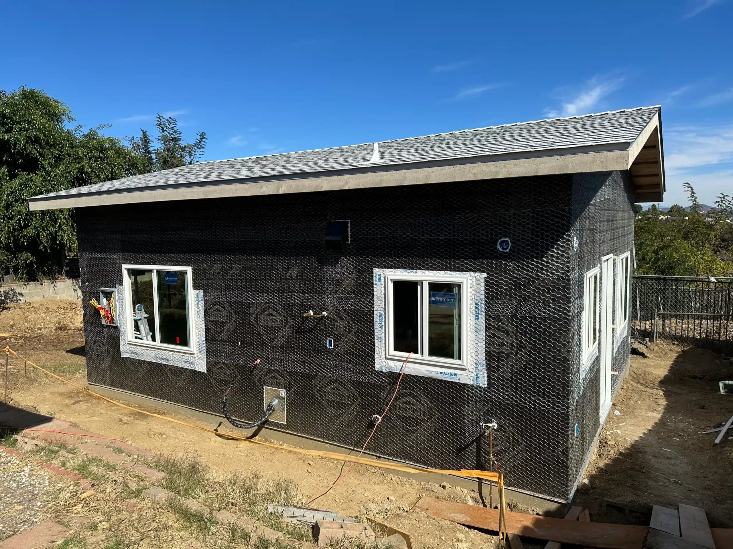ADU exterior wrapped in weather-resistive barrier with the windows installed
