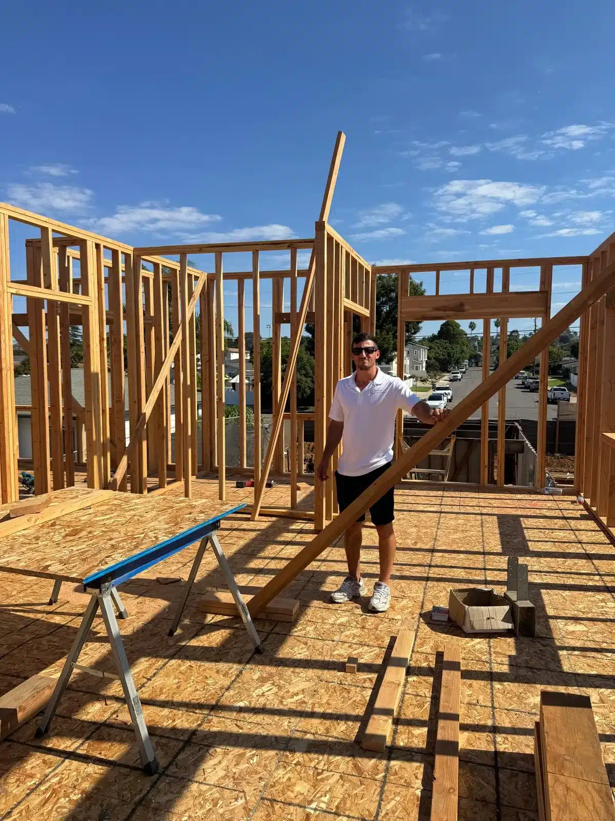 Exposed wood wall framing with window openings and diagonal bracing during construction